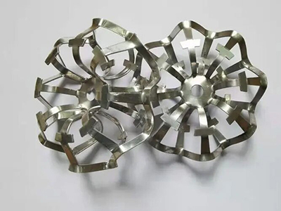 Metal packing for adipic acid production corrosion protection measures
